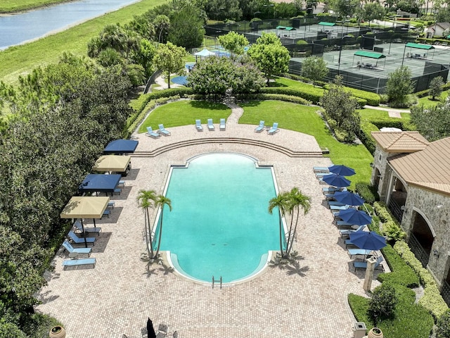 view of swimming pool with a patio and a water view