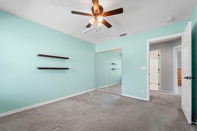 unfurnished bedroom with visible vents, a closet, carpet floors, and baseboards