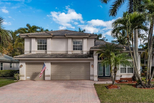 mediterranean / spanish house with a garage