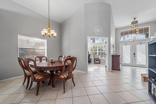 dining room featuring an inviting chandelier, light tile patterned floors, high vaulted ceiling, and french doors