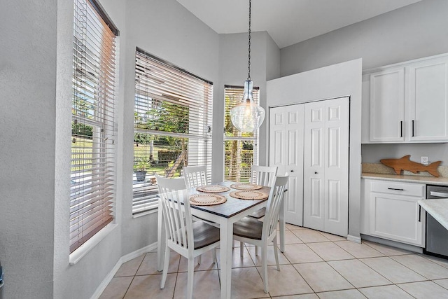 dining space featuring light tile patterned floors and baseboards