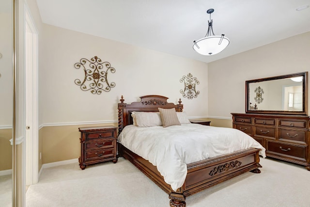 bedroom with light carpet and baseboards