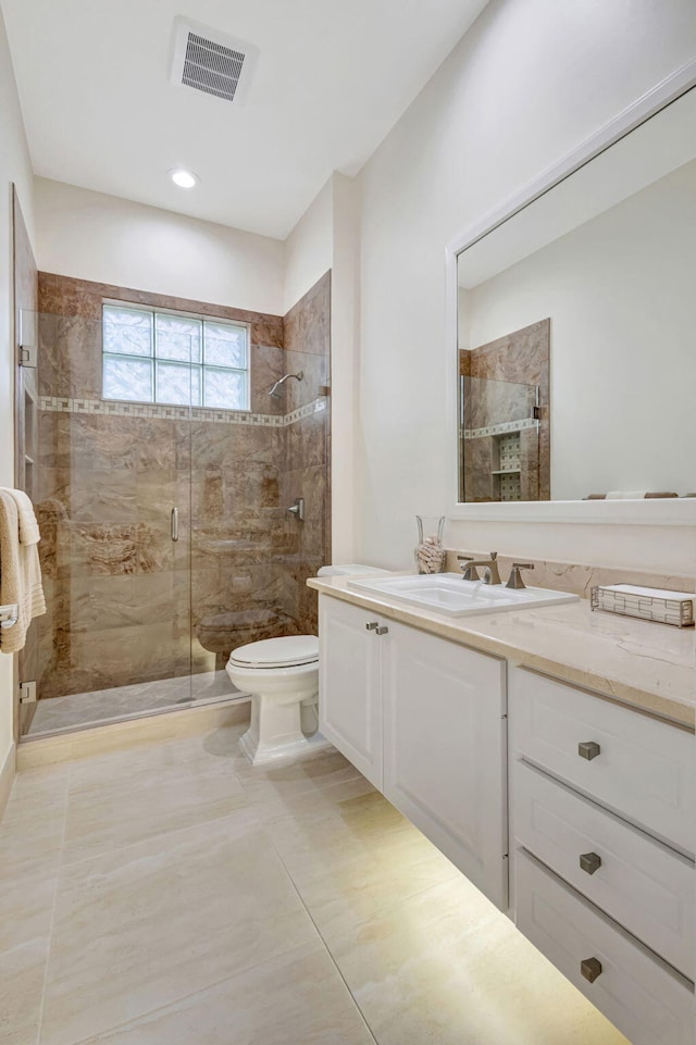 full bath with toilet, a stall shower, vanity, and visible vents