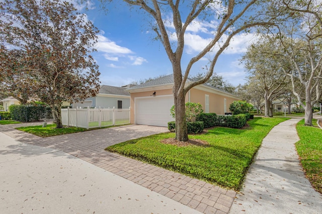 view of front of home with an attached garage, stucco siding, fence, a front lawn, and decorative driveway