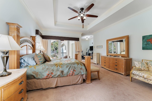 bedroom with multiple windows, a tray ceiling, crown molding, and carpet