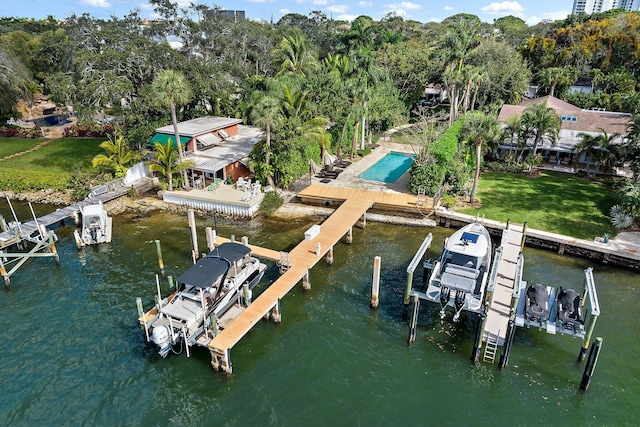 view of dock featuring a water view and a yard