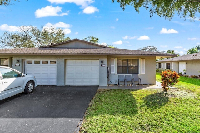 single story home with an attached garage, a shingled roof, driveway, stucco siding, and a front lawn