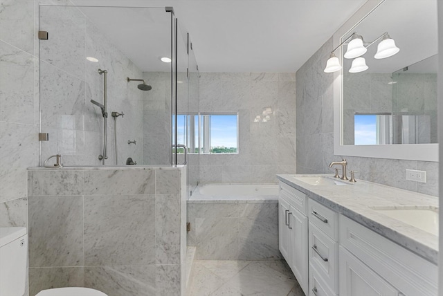 bathroom with vanity, separate shower and tub, and tile walls