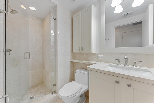 bathroom with tasteful backsplash, vanity, toilet, and an enclosed shower