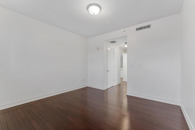 unfurnished room with dark hardwood / wood-style floors