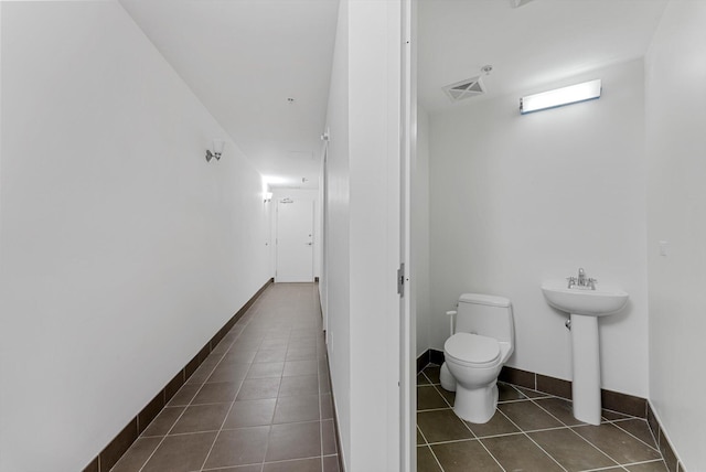 bathroom featuring tile patterned flooring, sink, and toilet