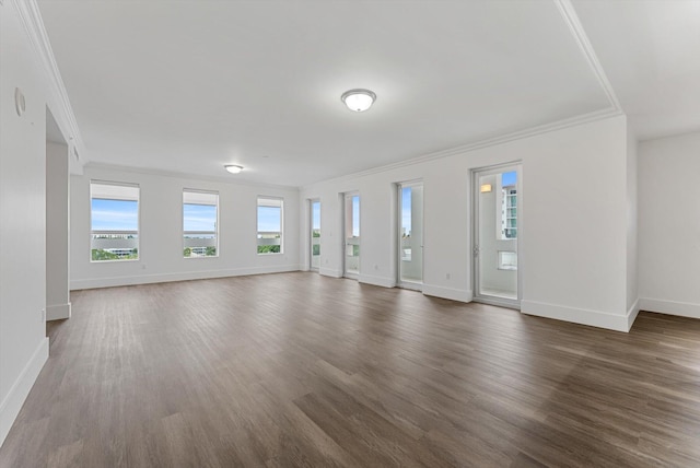 unfurnished living room with dark hardwood / wood-style flooring and ornamental molding