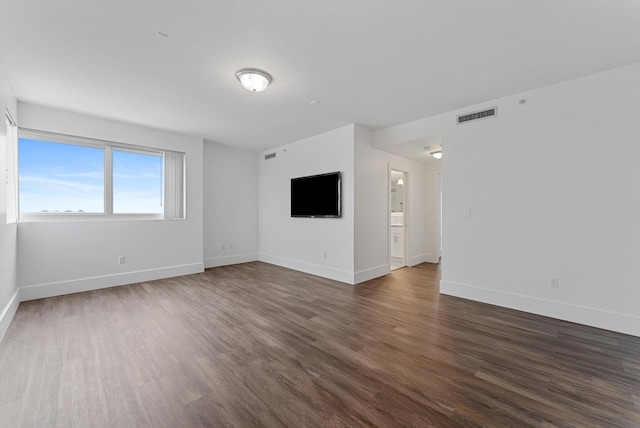 empty room featuring dark hardwood / wood-style flooring