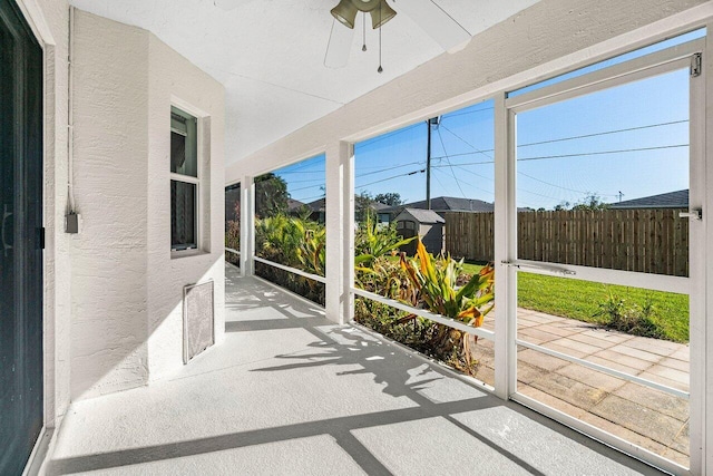 sunroom / solarium with plenty of natural light and ceiling fan