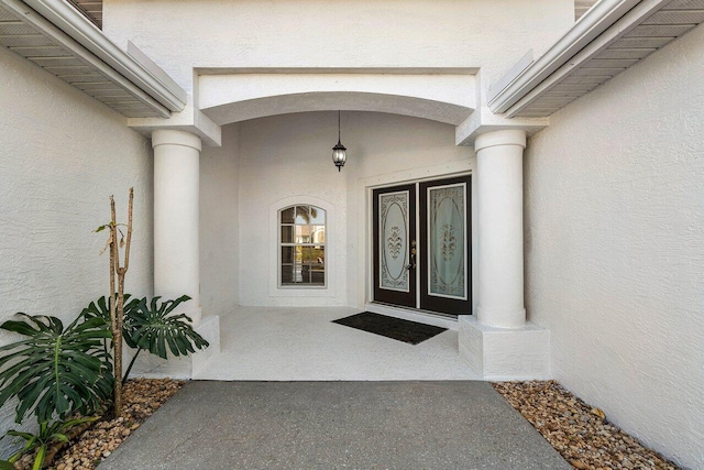 doorway to property featuring stucco siding