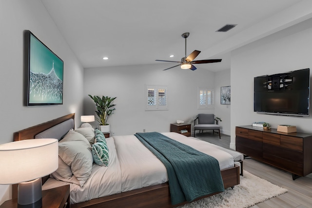 bedroom with light hardwood / wood-style flooring, ceiling fan, and vaulted ceiling