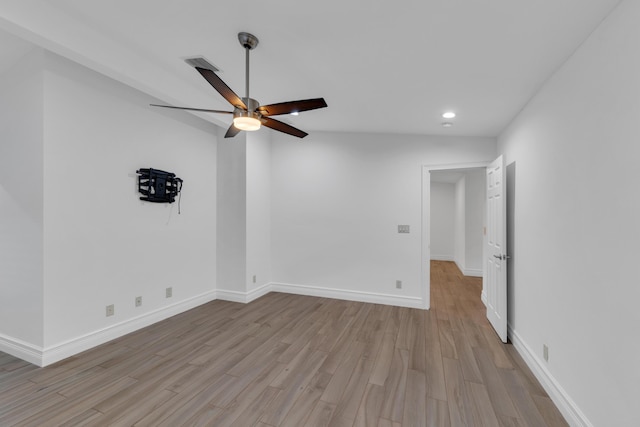 empty room featuring lofted ceiling, light hardwood / wood-style flooring, and ceiling fan