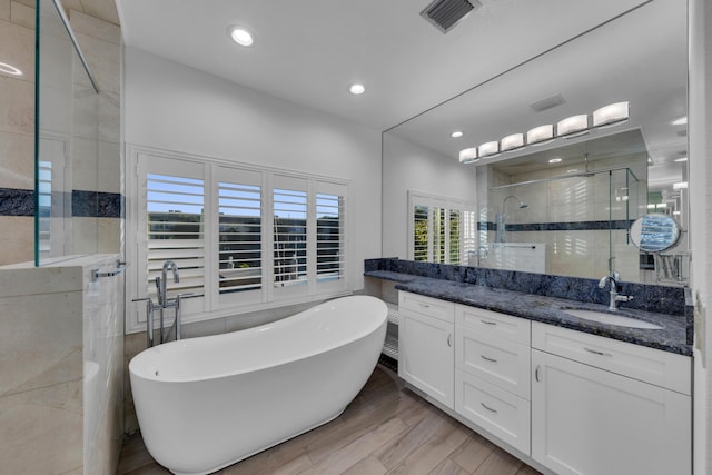 bathroom with vanity, wood-type flooring, and separate shower and tub