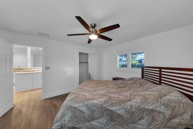 bedroom featuring ceiling fan, dark hardwood / wood-style floors, a closet, and a textured ceiling