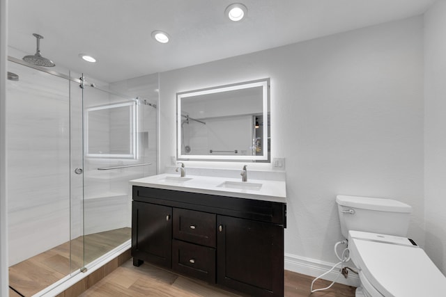 bathroom with walk in shower, vanity, and toilet