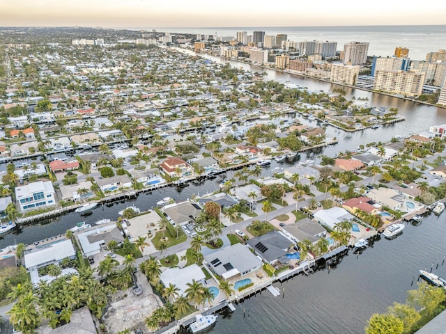 aerial view at dusk featuring a water view