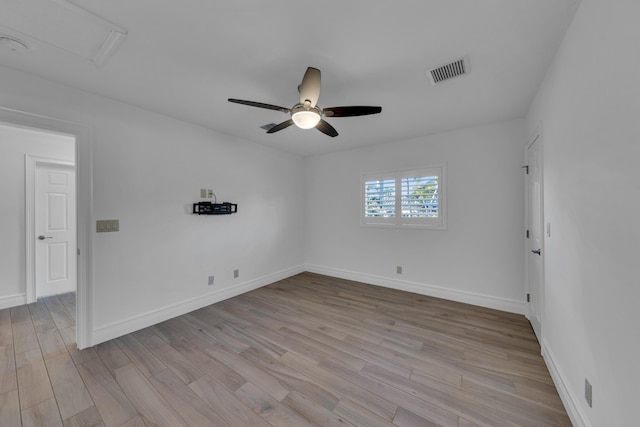 spare room featuring light hardwood / wood-style flooring and ceiling fan