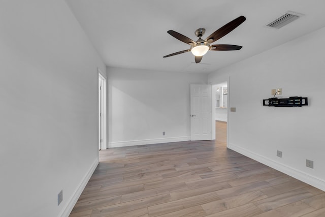 spare room with ceiling fan and light wood-type flooring