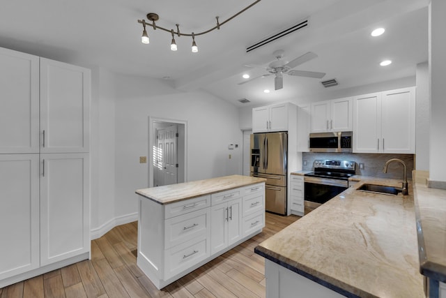 kitchen featuring white cabinetry, appliances with stainless steel finishes, sink, and light hardwood / wood-style floors