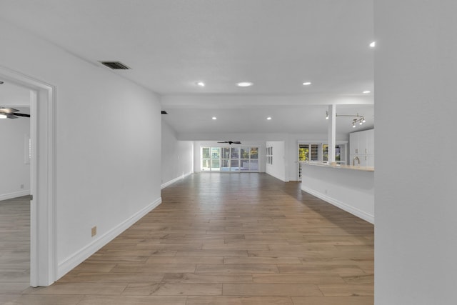 unfurnished living room with ceiling fan and light hardwood / wood-style flooring