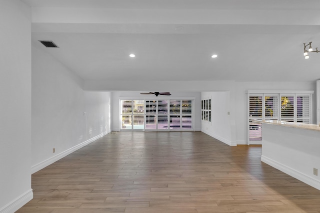 unfurnished living room with ceiling fan and light hardwood / wood-style flooring