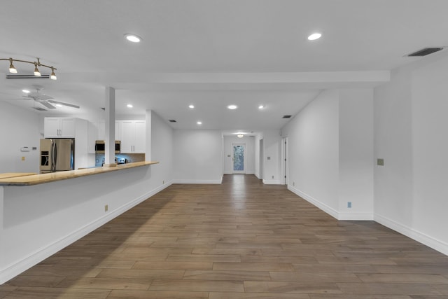 unfurnished living room featuring hardwood / wood-style floors and ceiling fan