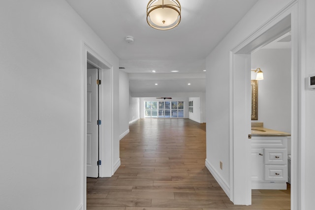 hall with light hardwood / wood-style floors