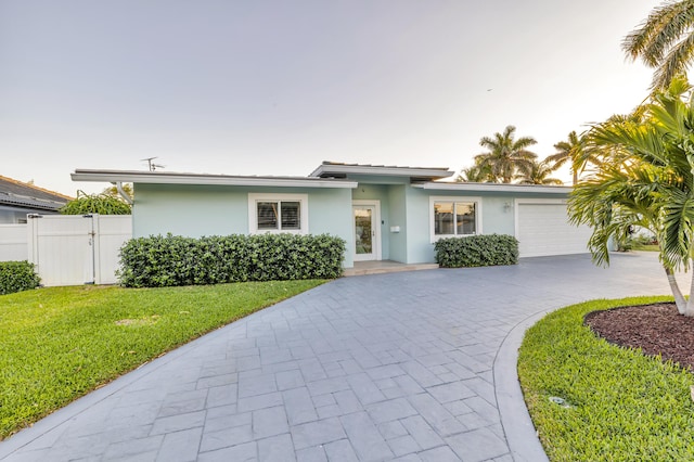 view of front of property with a garage and a front yard