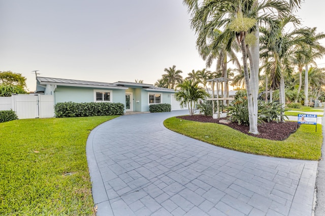 ranch-style home with a front lawn