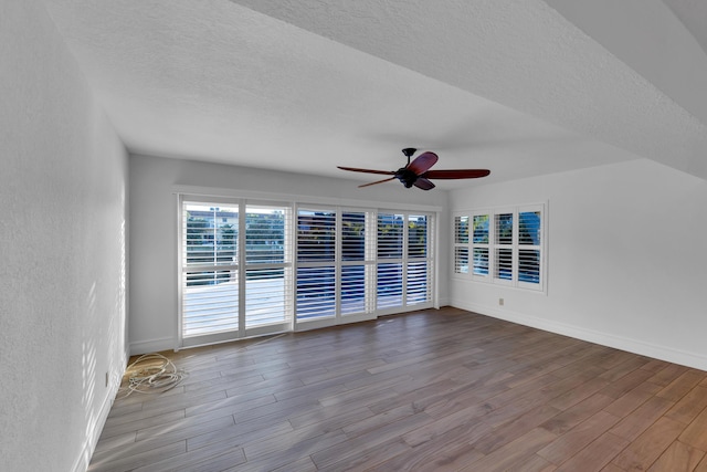 spare room featuring ceiling fan, a textured ceiling, and light wood-type flooring