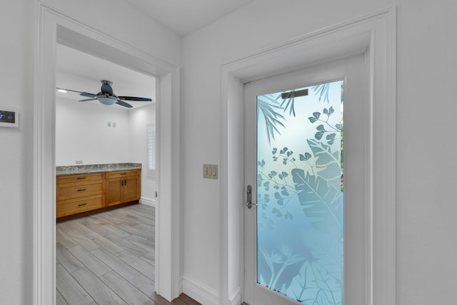 interior space with ceiling fan and light wood-type flooring