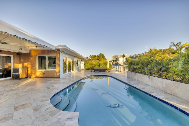 view of pool with a jacuzzi and a patio