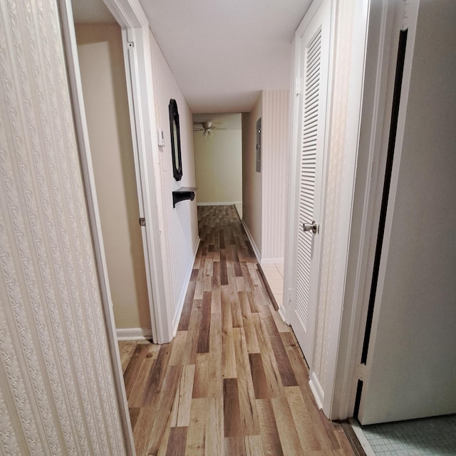 corridor with light hardwood / wood-style floors