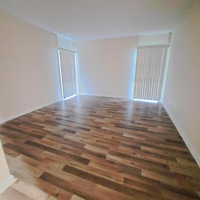 spare room featuring dark wood-type flooring