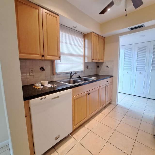 kitchen with sink, light brown cabinets, white dishwasher, and light tile patterned floors