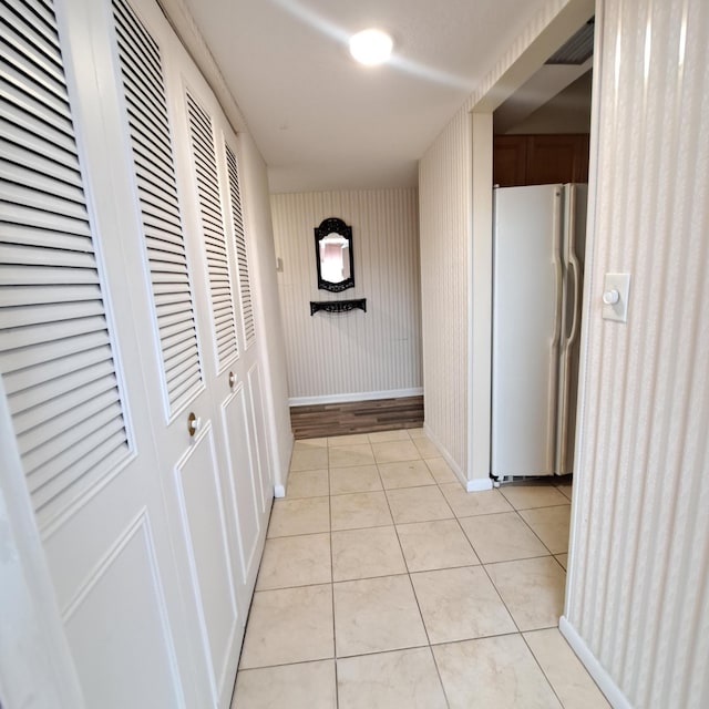 hall with light tile patterned floors