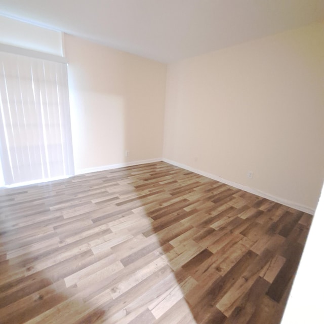 unfurnished room featuring light hardwood / wood-style floors