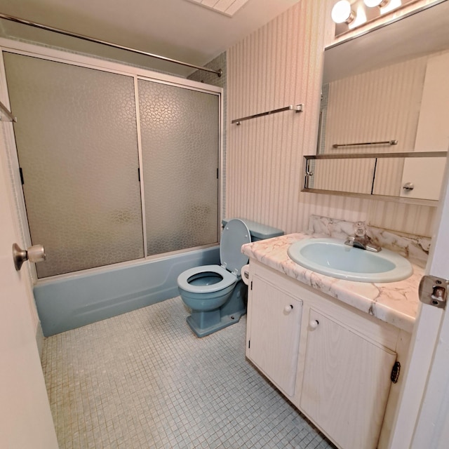 full bathroom featuring vanity, tile patterned flooring, shower / bath combination with glass door, and toilet