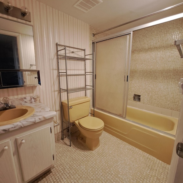 full bathroom featuring vanity, toilet, and combined bath / shower with glass door