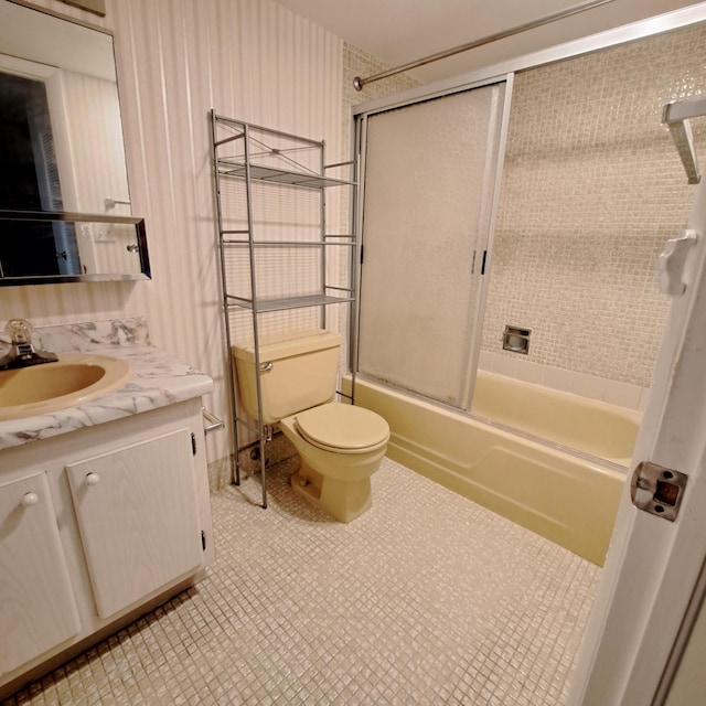 full bathroom with vanity, toilet, and bath / shower combo with glass door