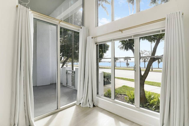 doorway to outside with a water view