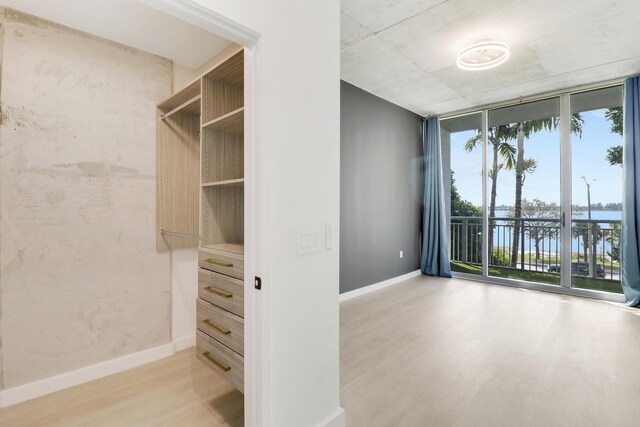 corridor with hardwood / wood-style flooring