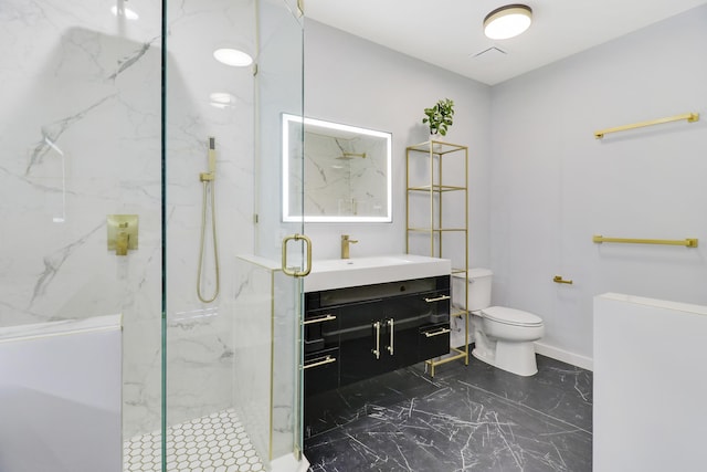 bathroom featuring toilet, vanity, and a shower with shower door