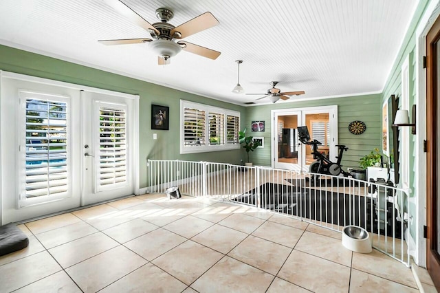 sunroom featuring french doors and a ceiling fan