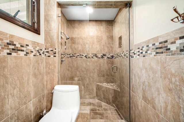 full bathroom featuring toilet, tile walls, and a shower stall